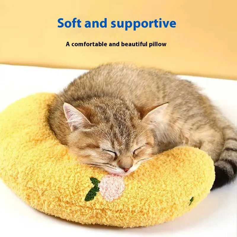 Blue and yellow U-shaped cat pillows in moon and question mark styles on a white background.