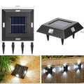 Solar-powered garden wall light mounted on outdoor brick wall illuminating pathway at night