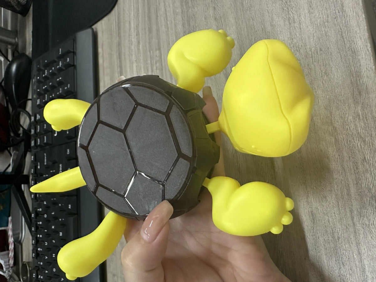Turtle-shaped ABS plastic coaster in a choice of four colours: light green, dark green, yellow, and wheat starch.