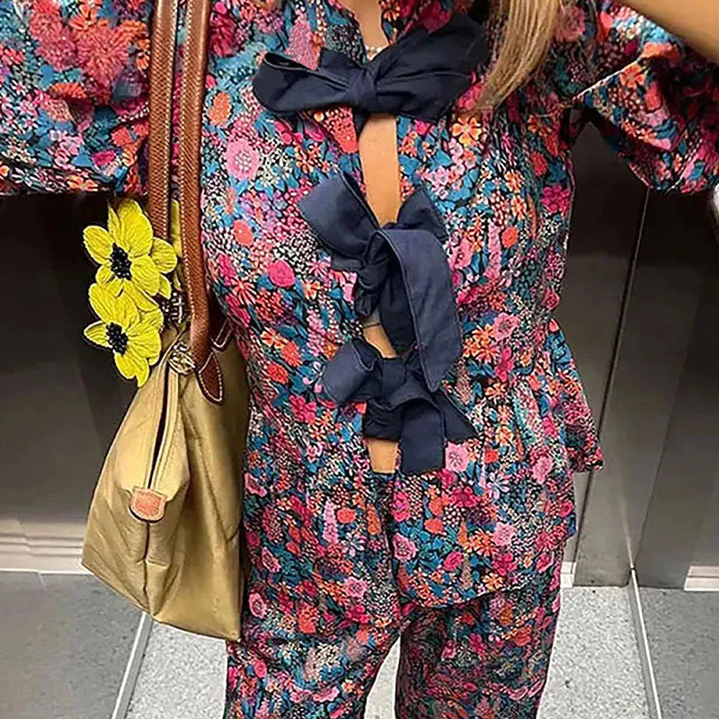 Women's floral print polyester trouser suit with puff sleeves and tie-neck blouse