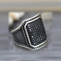 Black alloy ring with copper detailing and zircon accents shown in unisex design