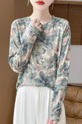 Floral print round neck pullover in knitted Tencel cotton fabric on a hanger.