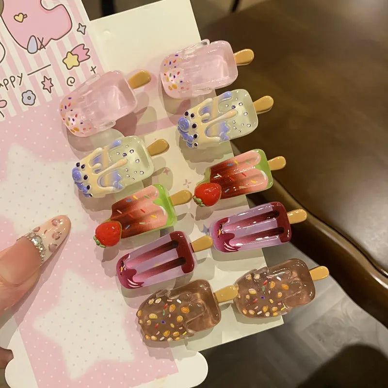 Cartoon ice cream themed resin barrette hair clip in side clip style on a colour background.