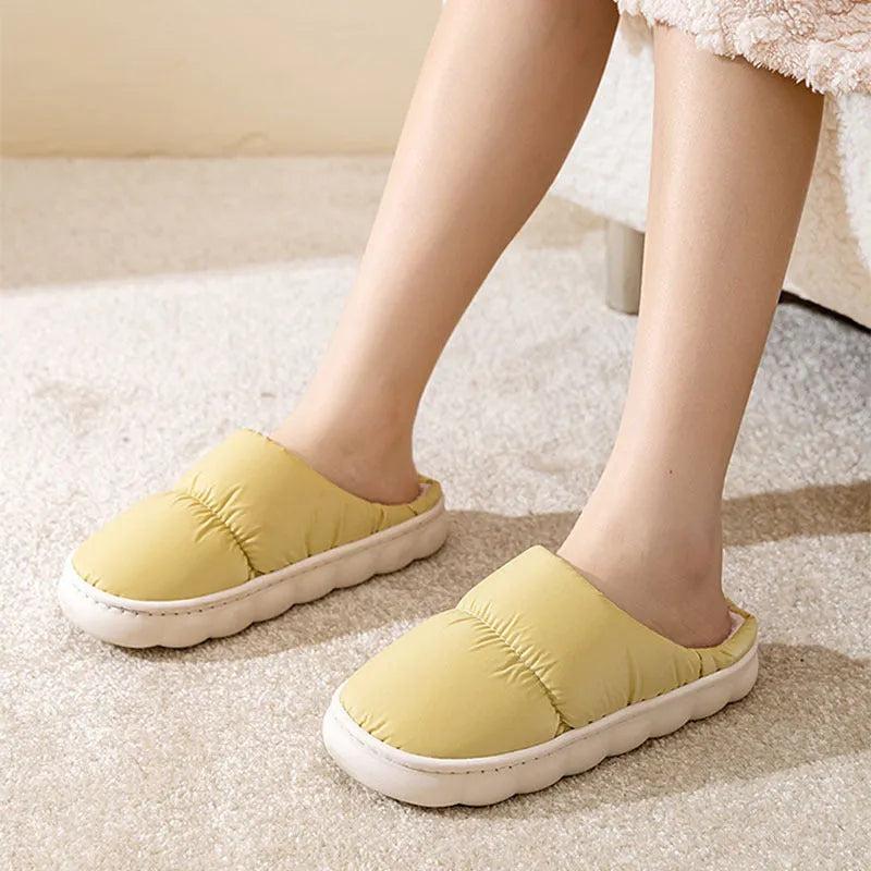 Blue down cotton slippers with a thick rubber sole and plush lining for indoor winter wear.