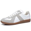 White Japanese-style retro low-top sneakers with round toe and lace-up front on a rubber sole.