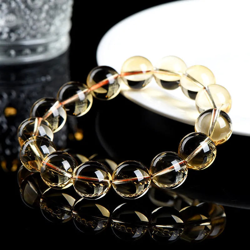 Natural citrine scattered beads ball bracelet showing polished gemstone beads in yellow-amber tones on a wrist.