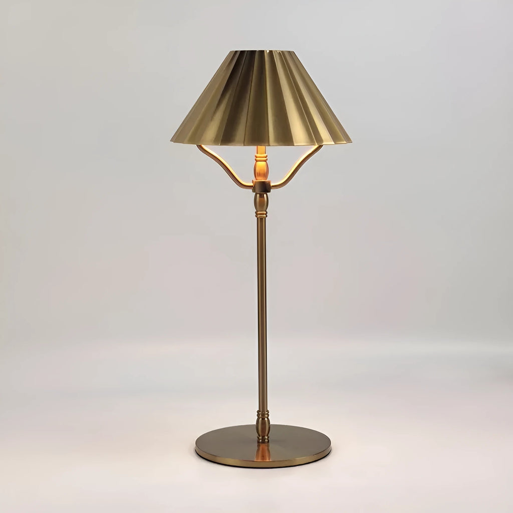 Gold alloy desk lamp with LED light source and interchangeable shade on wooden desk surface