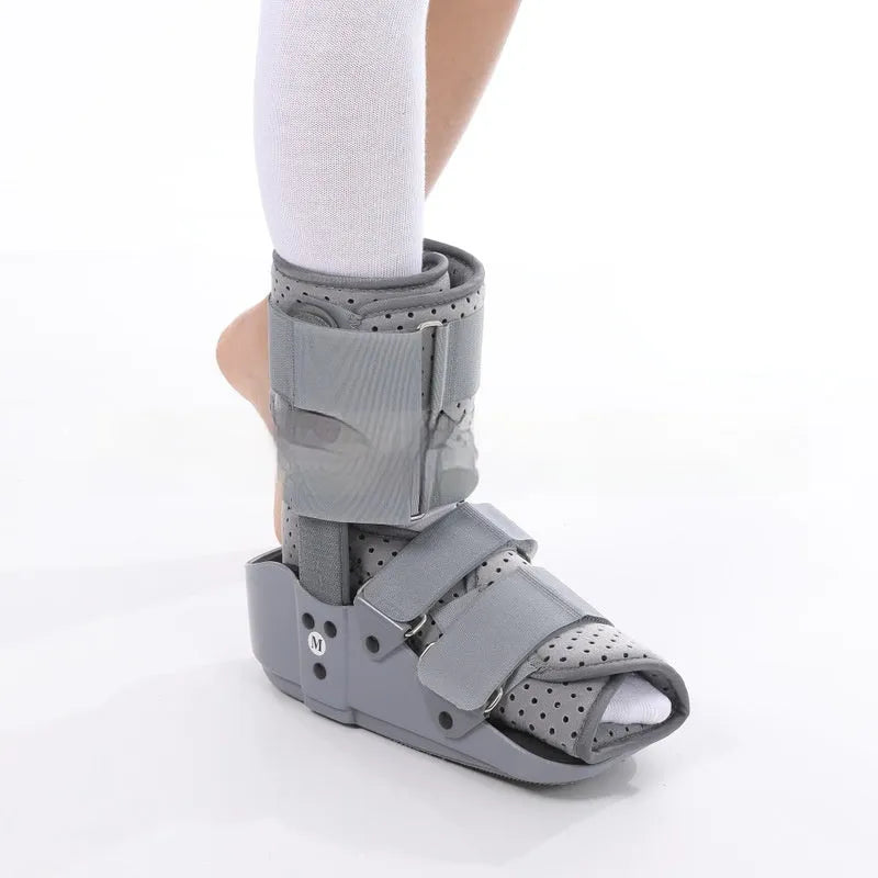 Grey and black Achilles tendon rehabilitation fixed support walking boot with adjustable straps.
