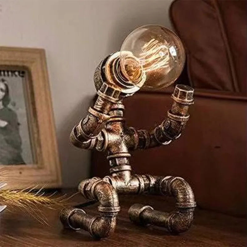 Iron pipe industrial retro robot design table lamp in retro colour on a wooden desk