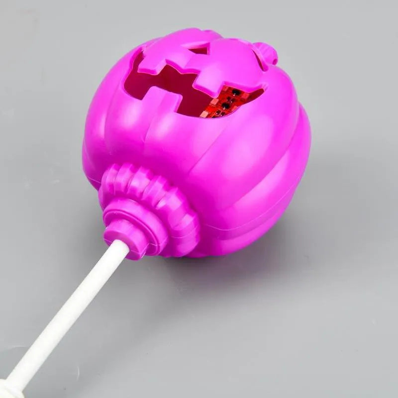 Plastic pumpkin-shaped USB rechargeable lamp glowing with either yellow or purple light, measuring 22cm tall.