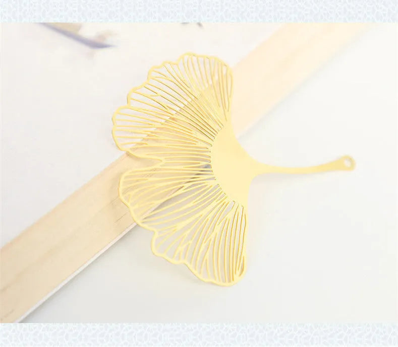 Brass metal bookmark with hollowed leaf design and rose gold tassel for book page marking