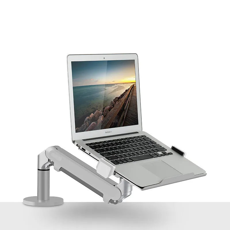 Black aluminium Free Hover adjustable laptop stand mounted on a desk edge, holding a silver notebook.