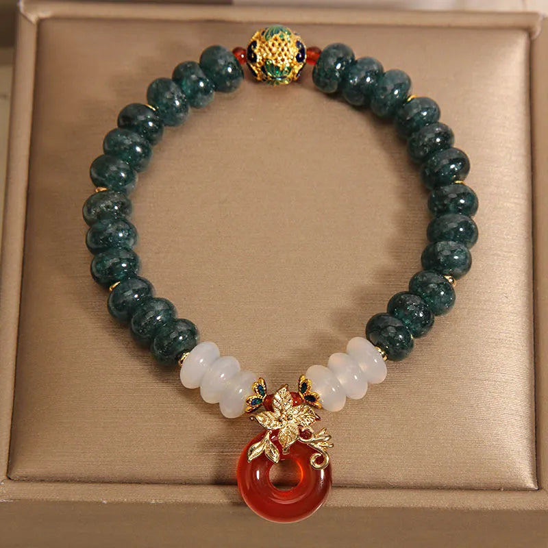 Blue jade and red agate bead bracelet with a crystal peace buckle closure.