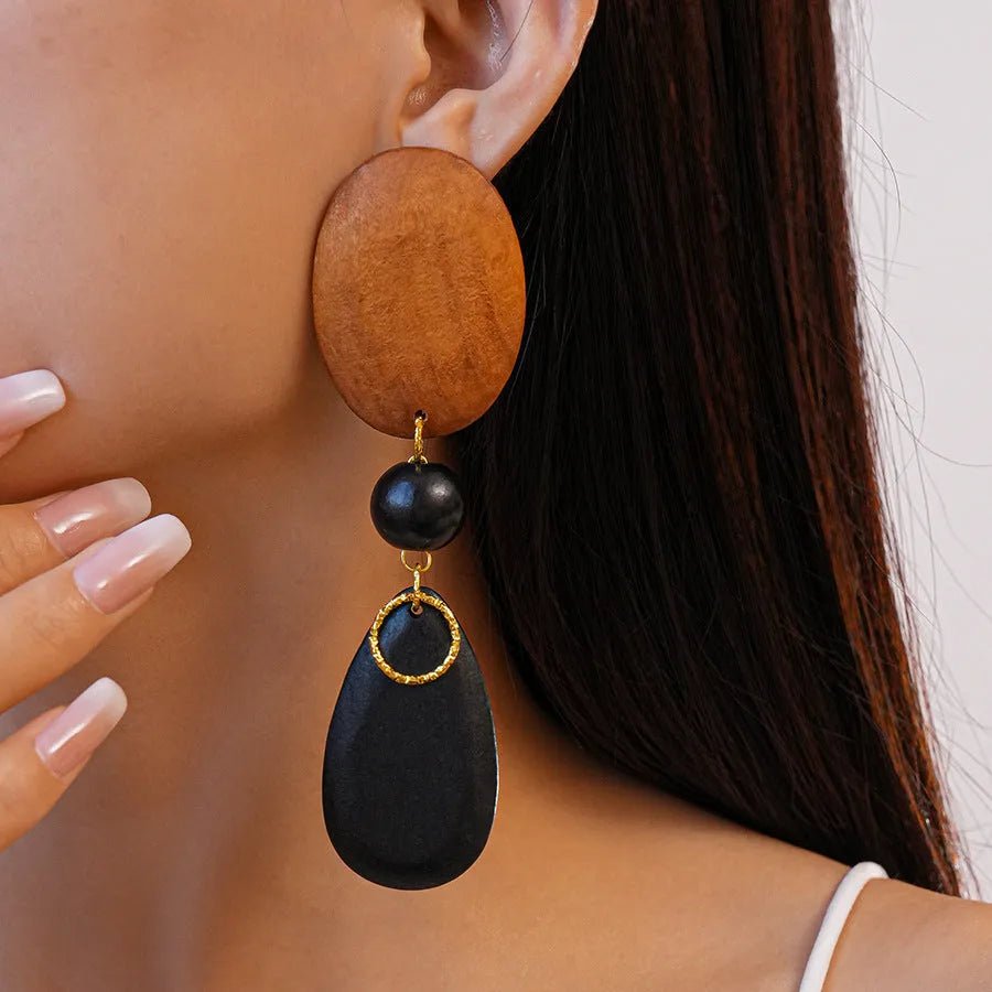 Hand-crafted wooden oval earrings in silver needle and brown-black retro style.
