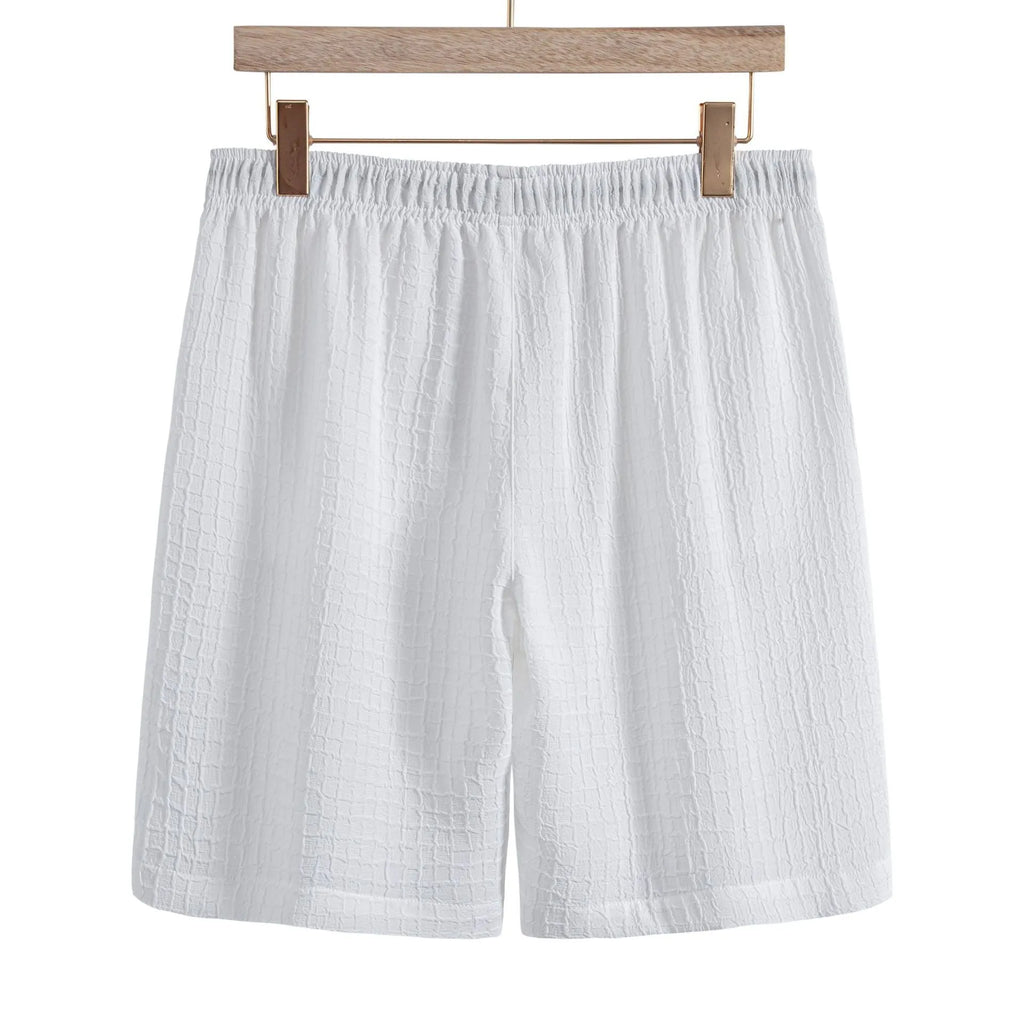 Man wearing a white cotton blend jacquard short sleeve shirt and matching shorts from a casual suit set.