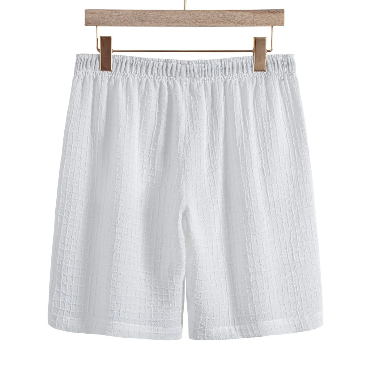 Man wearing a white cotton blend jacquard short sleeve shirt and matching shorts from a casual suit set.