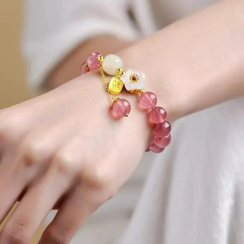 Handmade women's strawberry quartz crystal bracelet with pearl, moon, and XINGX designs