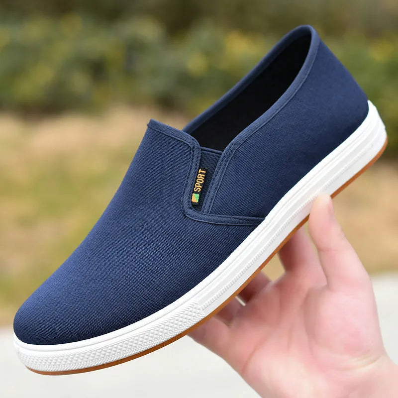 Men's black and blue low-top canvas slip-on shoes with round toe and composite soles