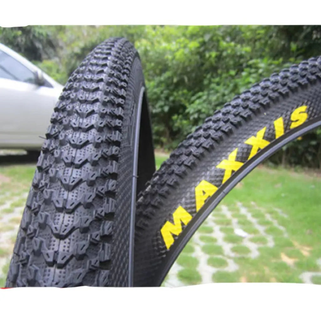 Ultralight black mountain bike tyre with puncture proof tread, shown in 26, 27.5 and 29 inch sizes.