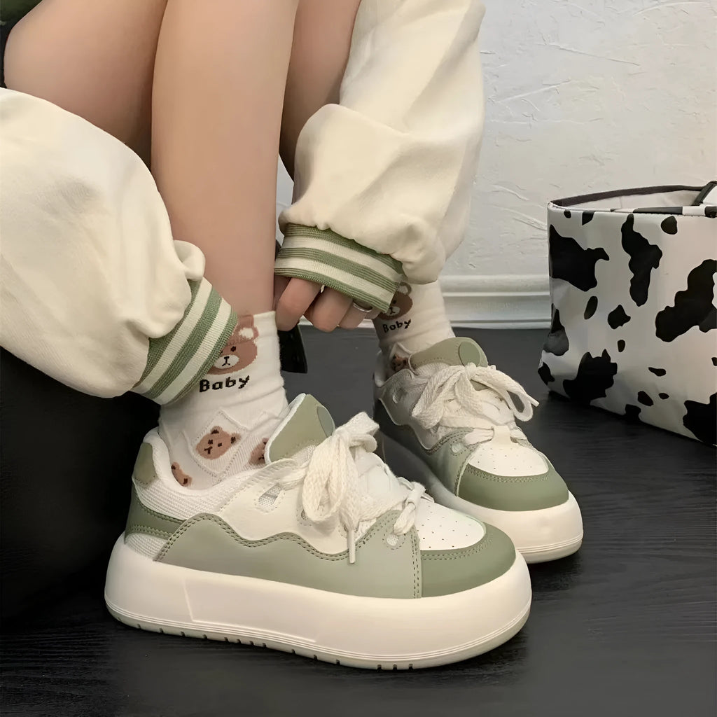 Green women's casual shoes with PU mesh upper, flat heel, and round toe on a plain background.