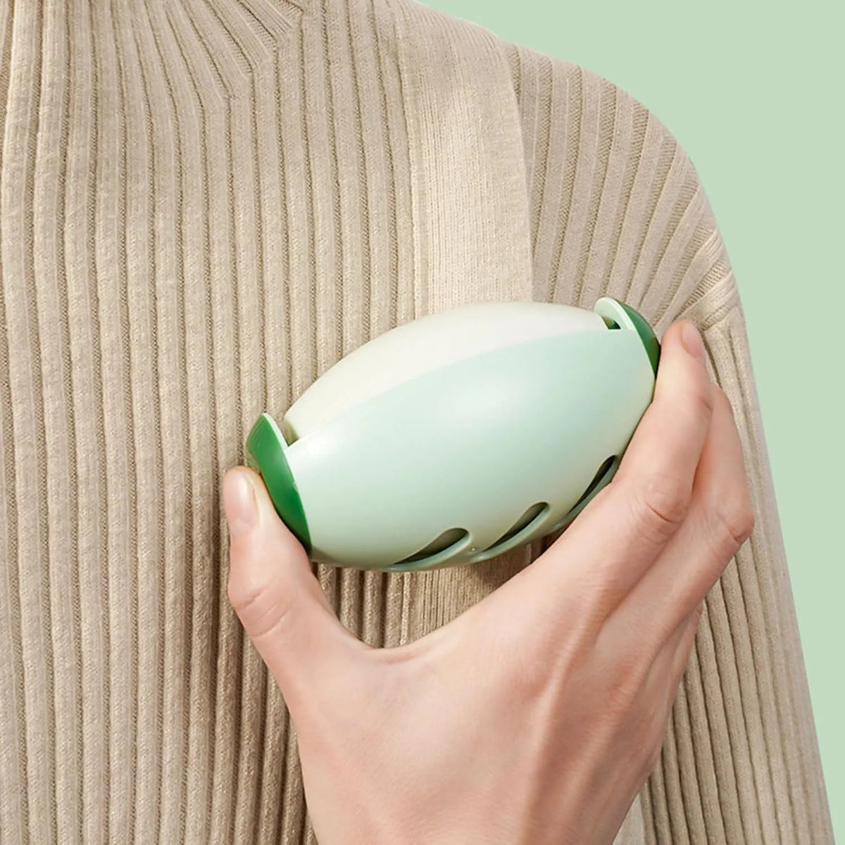 Four green and white washable reusable gel lint roller balls for portable pet hair removal.
