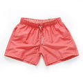 Men's polyester beach shorts in black with straight leg opening and grinded fabric texture available in sizes S to 4XL