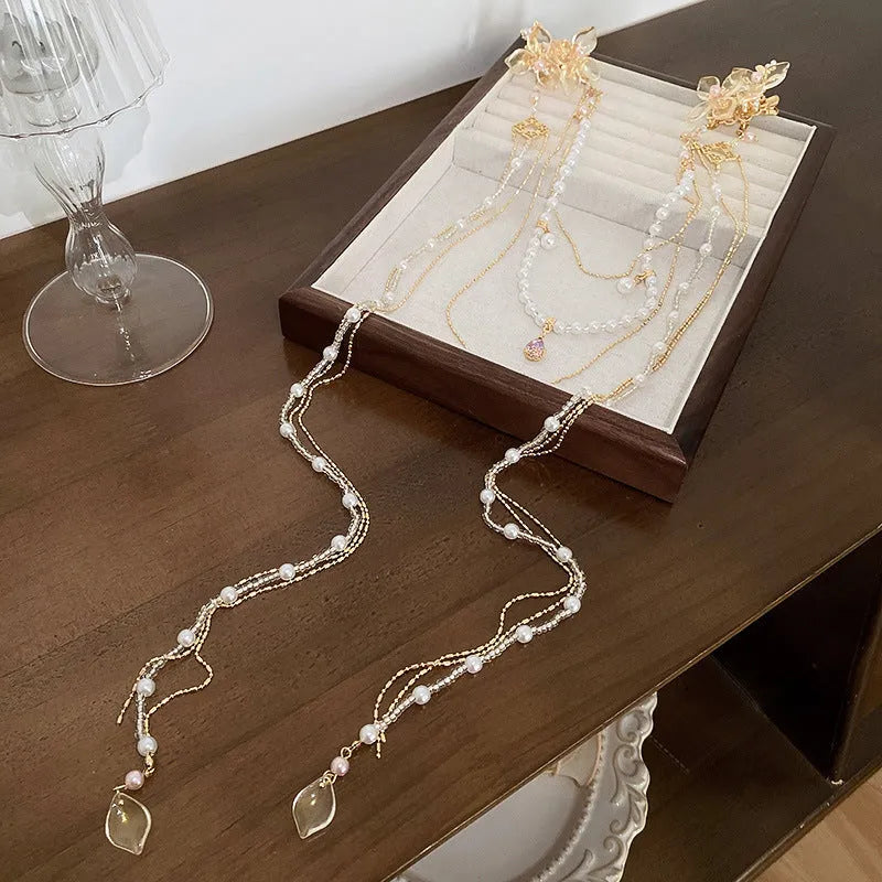 Gold women's hairpin with diamond grip and long tassel design