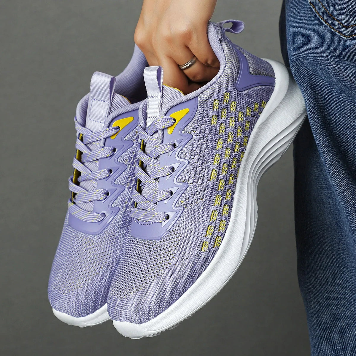 Women's Lavender Purple Flyknit running shoes with mesh upper and striped pattern on an EVA sole.