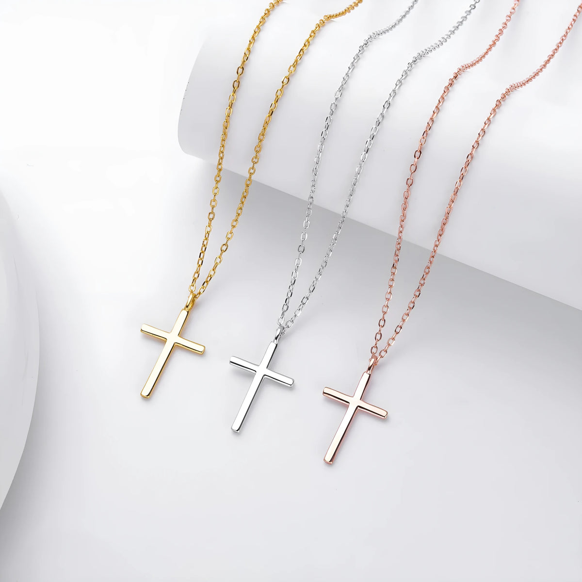 Simple glossy cross pendant on an adjustable O-chain sterling silver necklace in gold plating