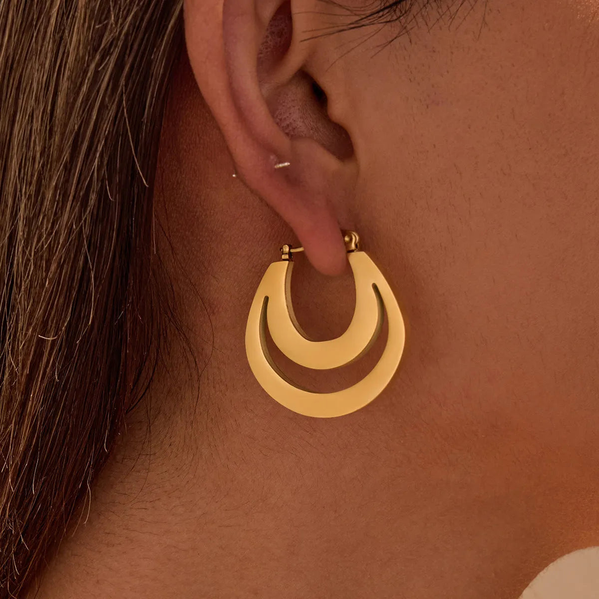 Geometric French earrings with round ring design in 18K gold-plated stainless steel, shown in gold and steel silver finishes.
