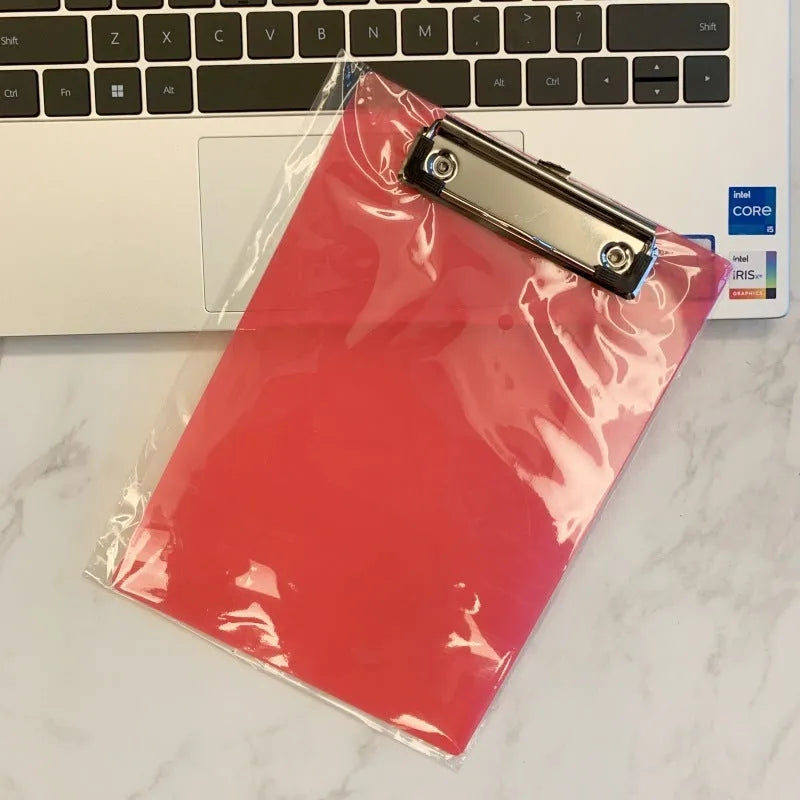 Clear plastic A4 plate holder with metal clip holding documents, available in multiple colours including blue, green, red and white.
