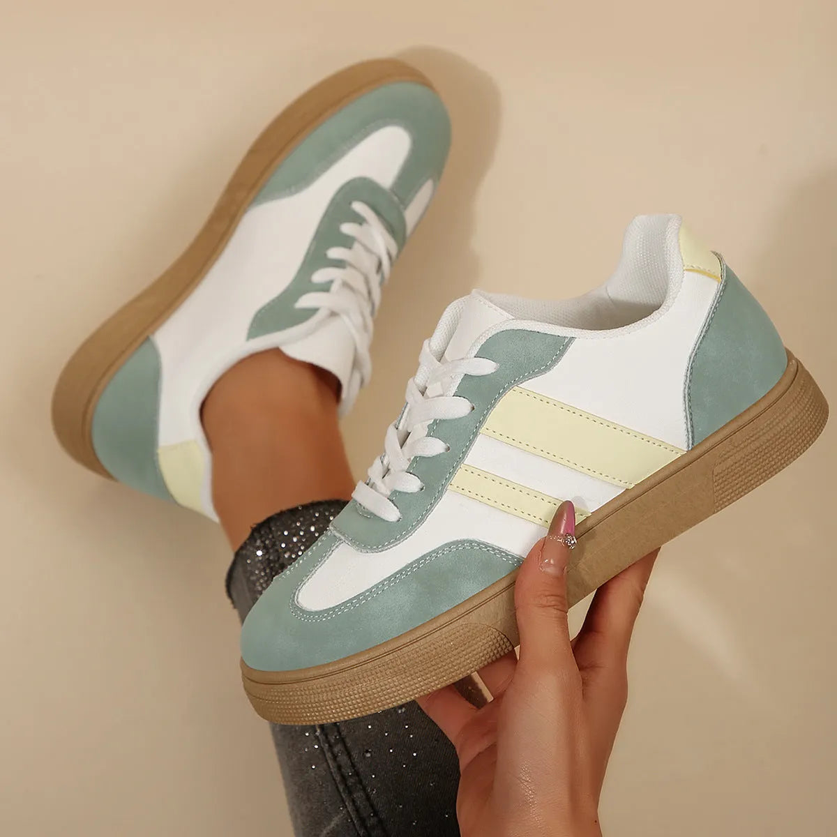 Green women's retro sports pumps with white cross straps and a round toe.