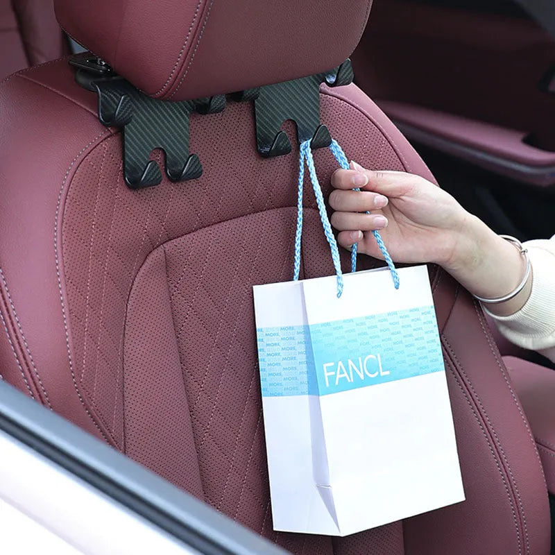 Black ABS car hook with integrated mobile phone bracket for rear seat storage.