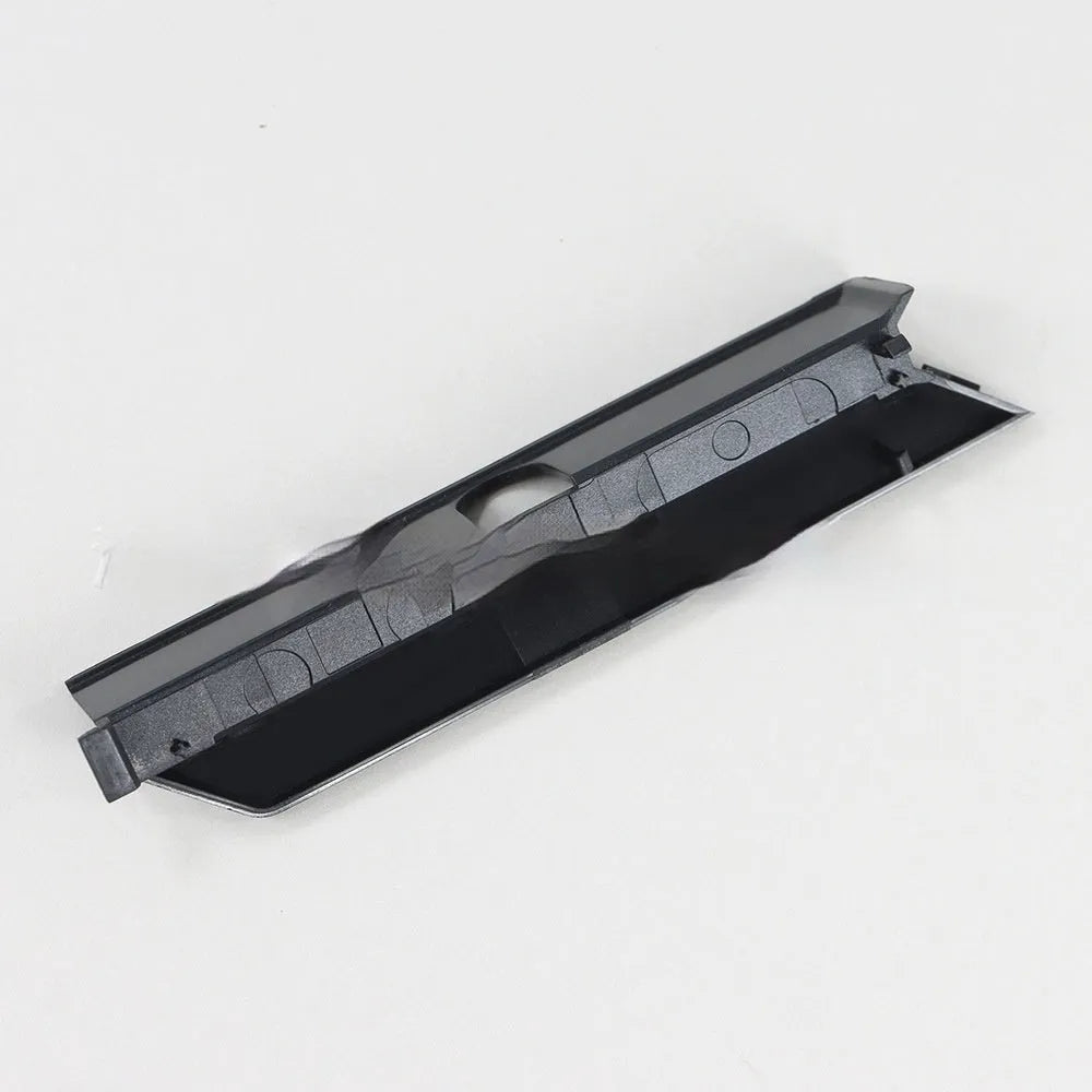 Black and white plastic hard drive blanking plates for PC computer cases.