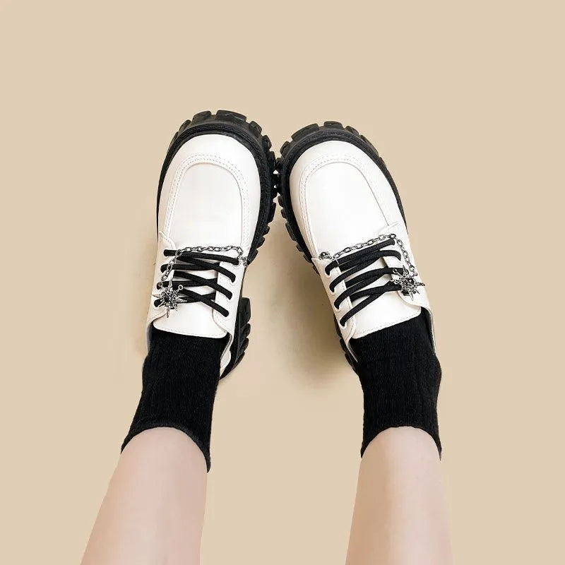 Women's Duke Asterism loafers with a metal cross strap and round toe in preppy college style.