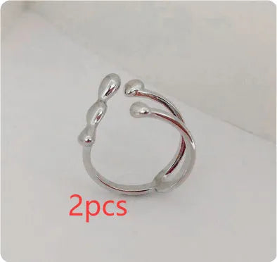 Adjustable brass opening ring with spherical detail in gold or silver colour