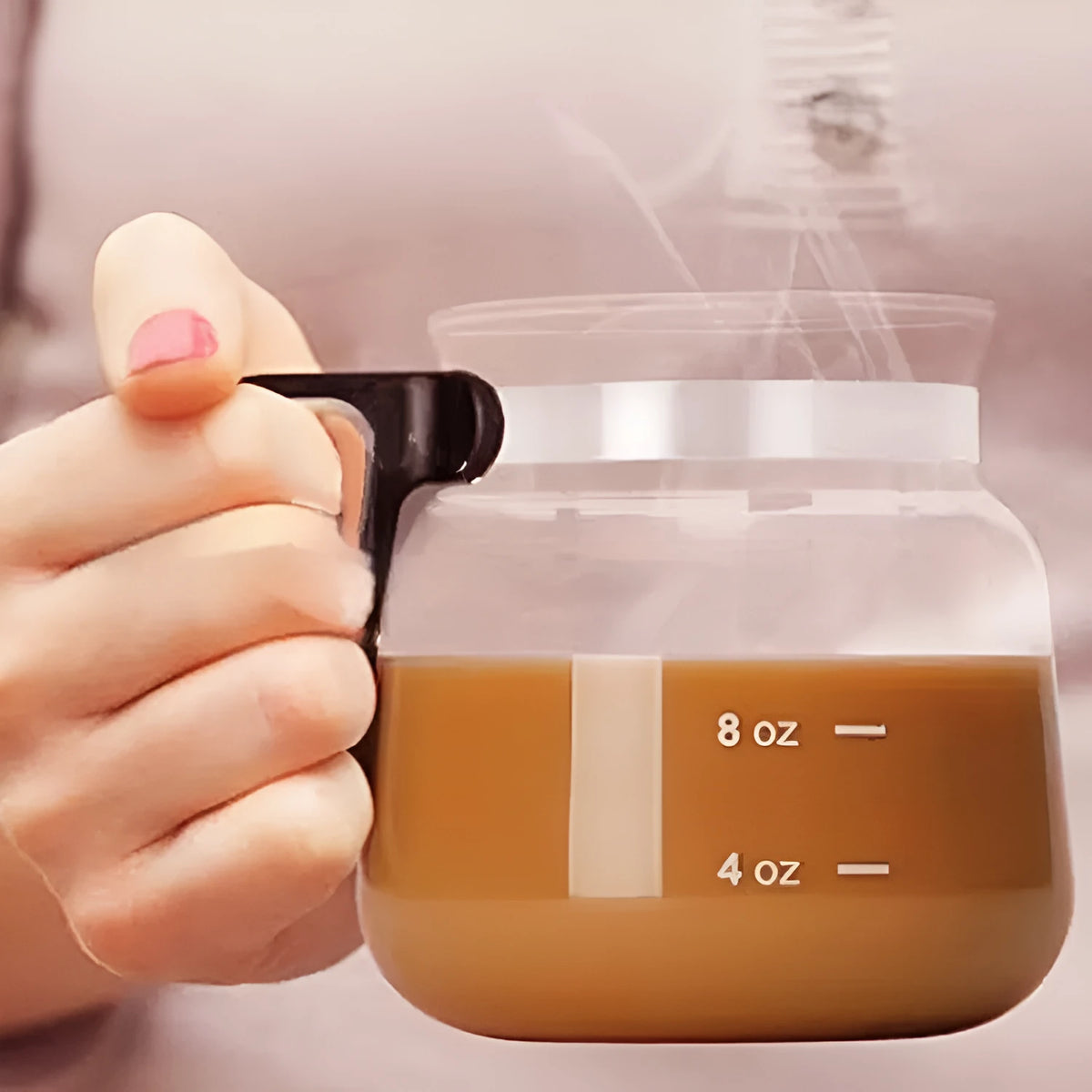 Transparent borosilicate glass coffee maker with a black silicone cover.