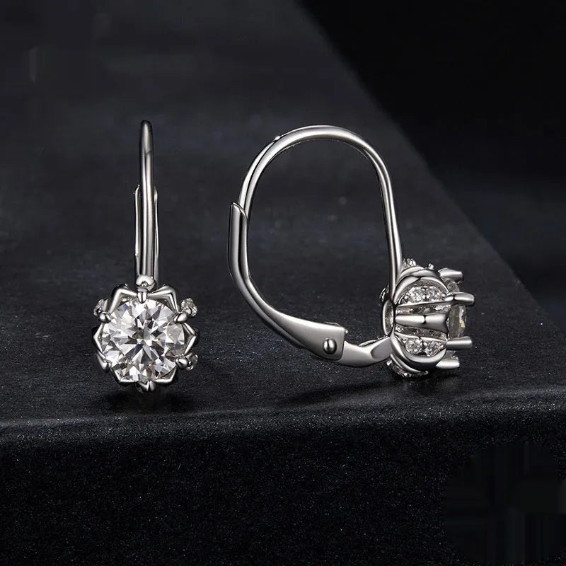 Sterling silver flower bud clip earrings with moissanite stone and white gold plating.