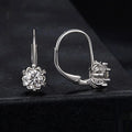 Sterling silver flower bud clip earrings with moissanite stone and white gold plating.