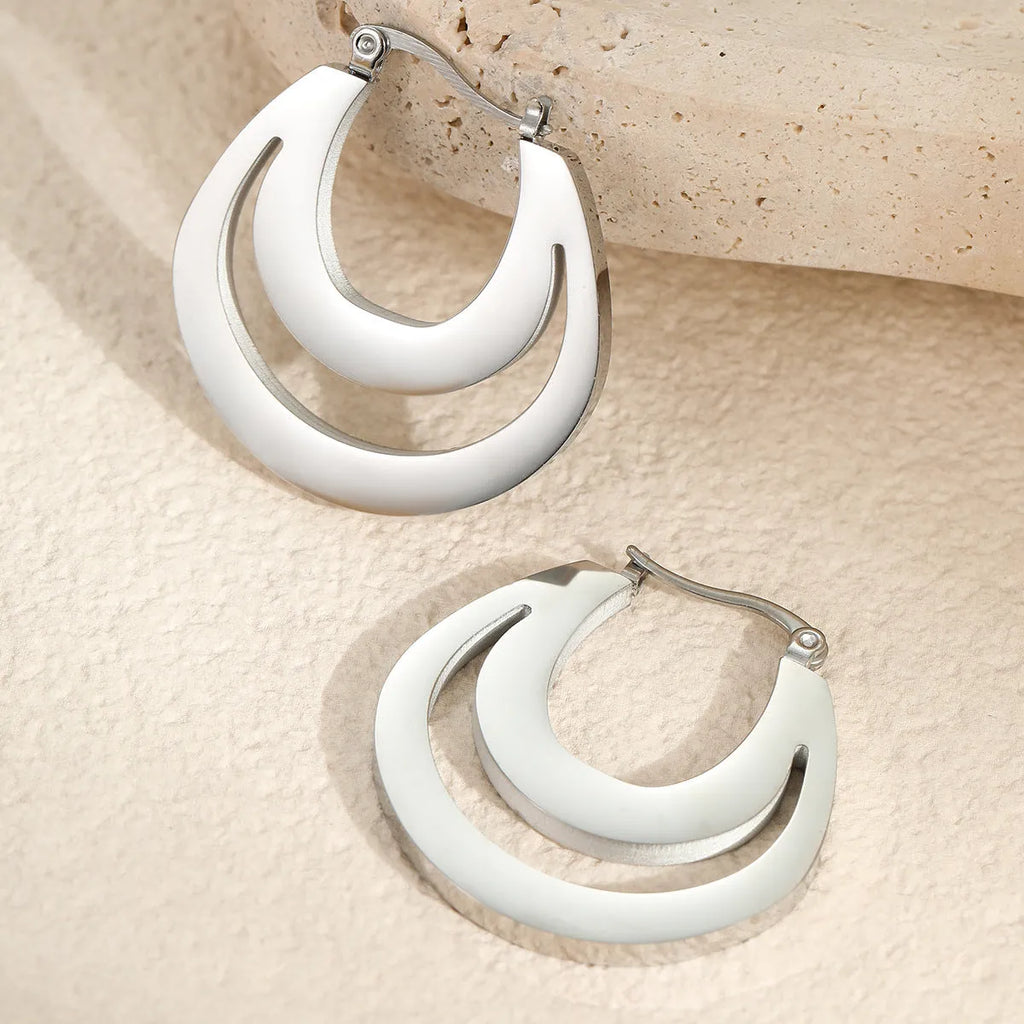 Geometric French earrings with round ring design in 18K gold-plated stainless steel, shown in gold and steel silver finishes.