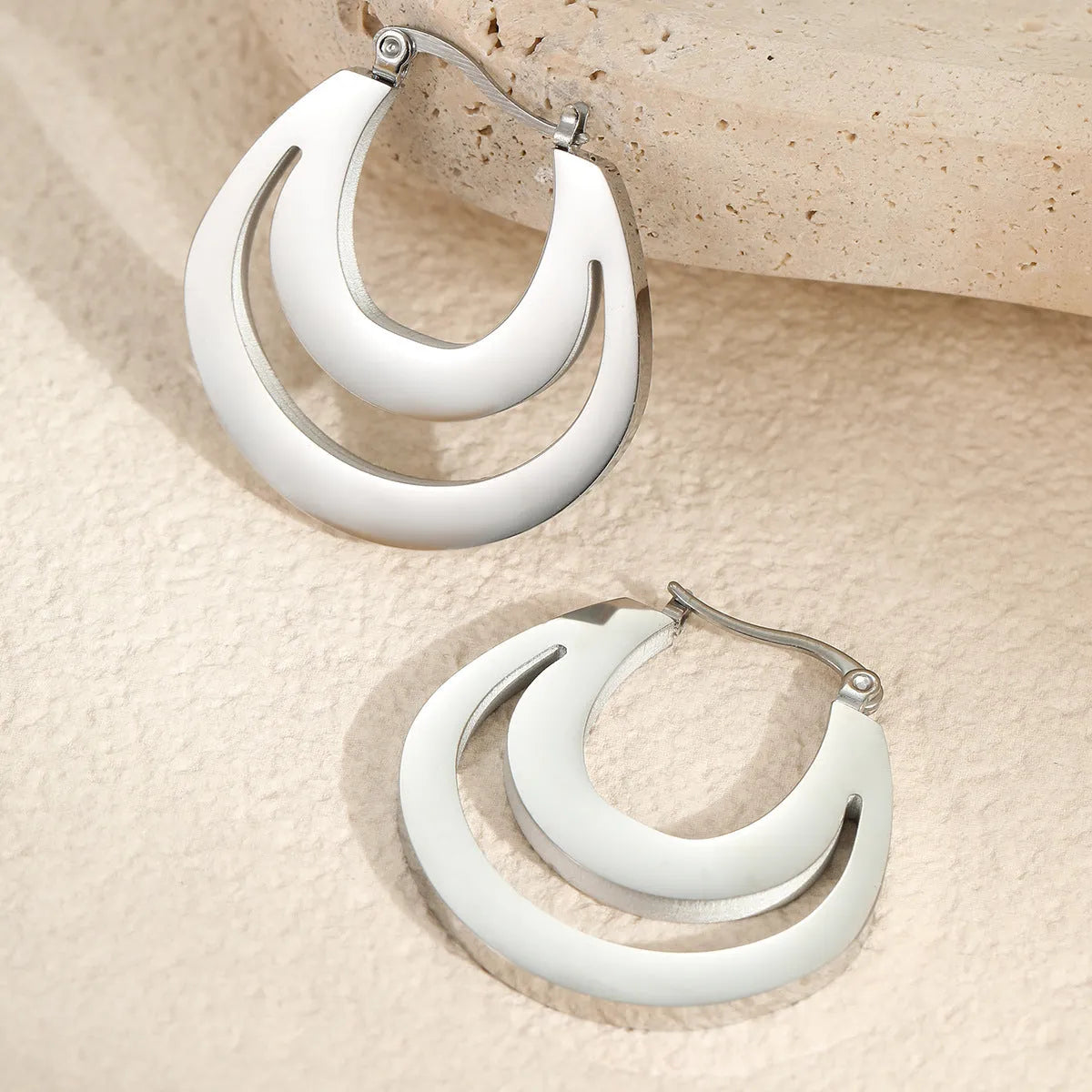 Geometric French earrings with round ring design in 18K gold-plated stainless steel, shown in gold and steel silver finishes.