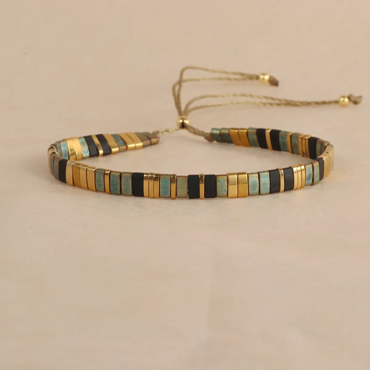 Glass bead geometric bracelet with round beads in five colour variations on wrist