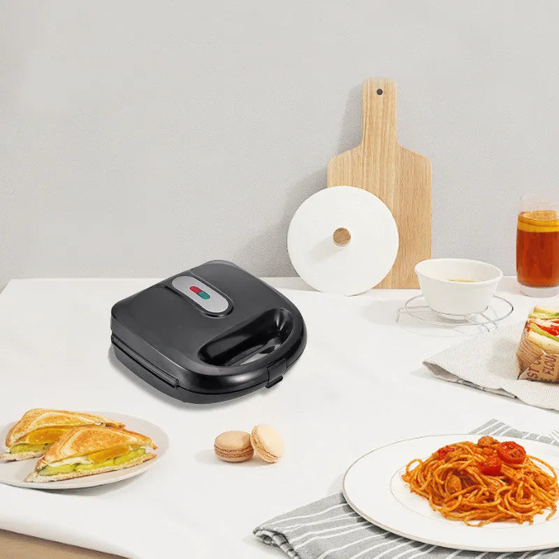 Black double-sided electric sandwich pan with stainless steel lid and non-stick coating.