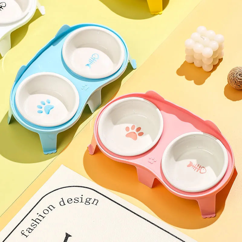 Ceramic elevated cat bowl set with tilted feeding platform on ABS stand in blue, pink, white, or yellow