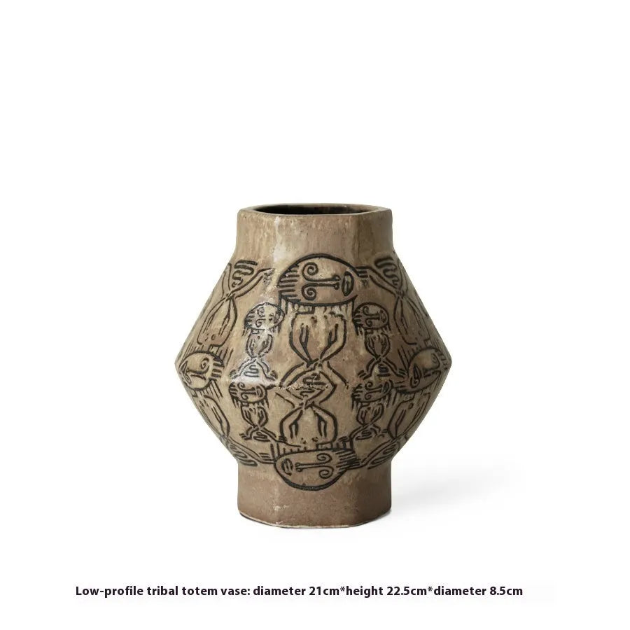 Hand-painted ceramic cylindrical vase with carved religious patterns in tribal totem flower design