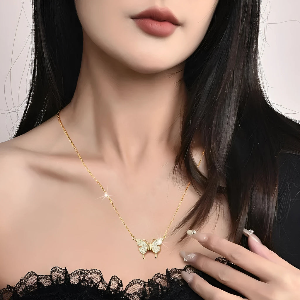 Gold titanium steel women's butterfly charm necklace on a twisted chain with magnetic clasp.