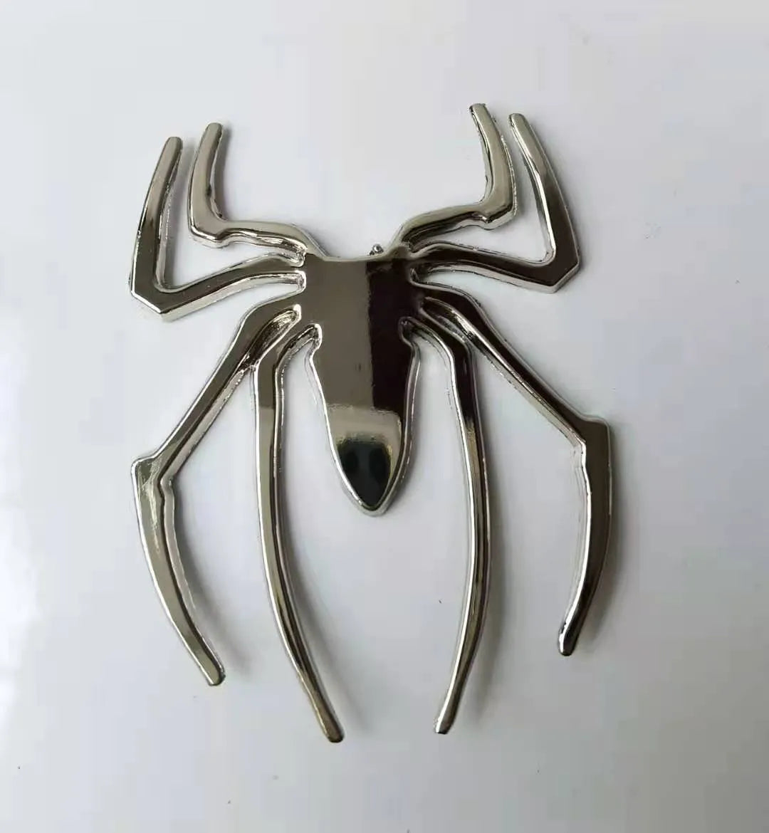 Three-dimensional zinc alloy spider bumper sticker in gold colour measuring 7cm by 5cm