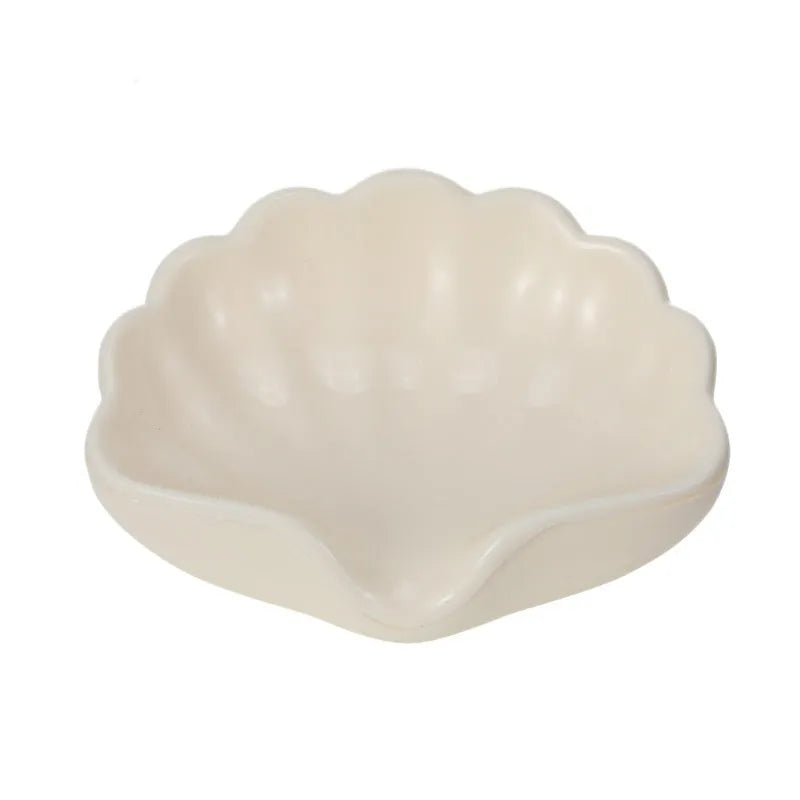 Shell-shaped white plastic soap dish with drainage for bathroom use