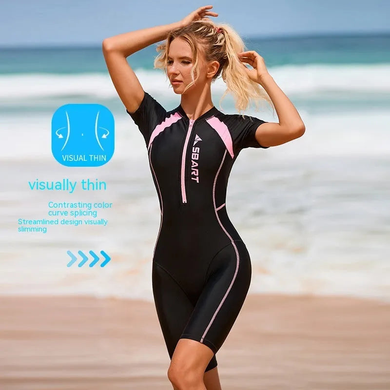 Adult woman modelling a solid colour, short-sleeve one-piece swimsuit with a chest pad.