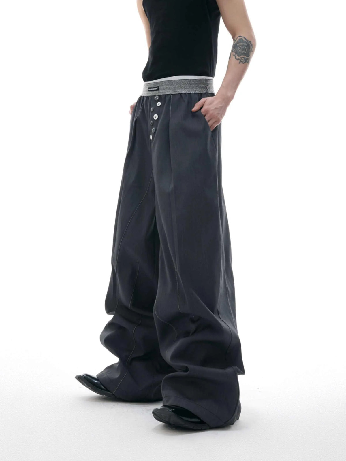 Black straight leg trousers with high waist design and button detail on front